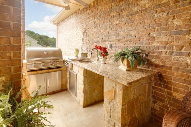 view of patio / terrace with a grill, exterior kitchen, and sink