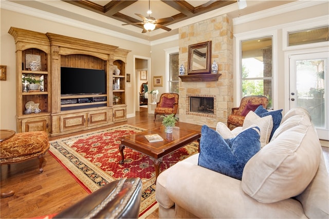 living room featuring coffered ceiling, crown molding, beam ceiling, a fireplace, and hardwood / wood-style floors