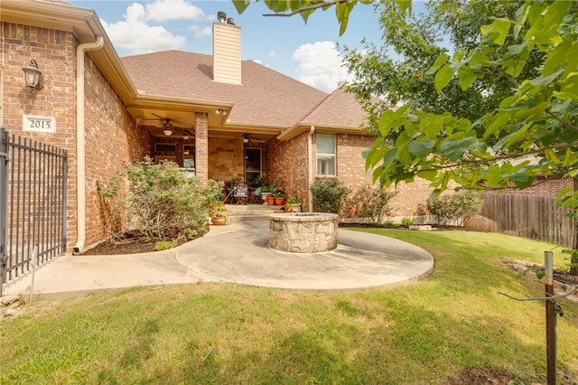 rear view of house with a lawn, ceiling fan, and a patio