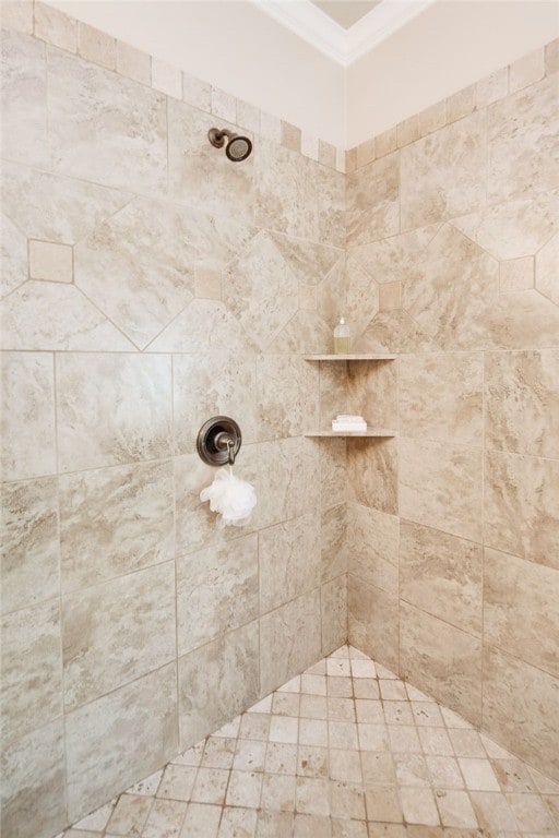 bathroom featuring a tile shower and crown molding