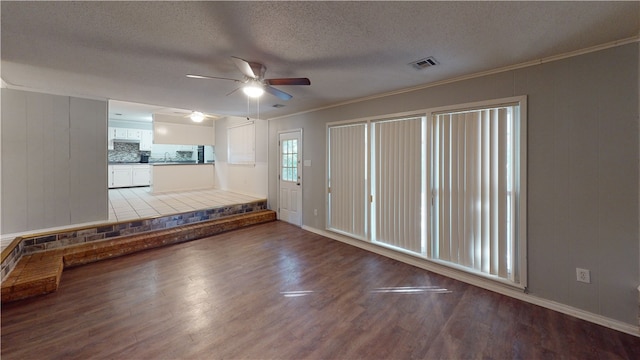 unfurnished living room featuring hardwood / wood-style floors, ceiling fan, crown molding, and a textured ceiling