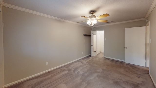 carpeted spare room featuring a textured ceiling, ceiling fan, and ornamental molding