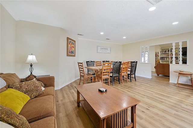 living room featuring a textured ceiling and light wood-type flooring