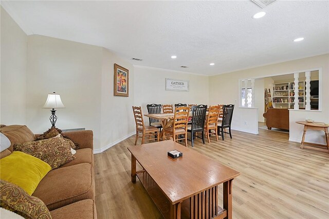 living room featuring a textured ceiling and light wood-type flooring