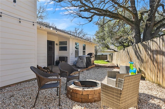 view of patio / terrace featuring a grill and an outdoor fire pit