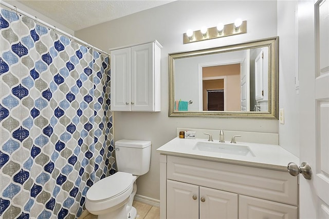 bathroom with tile patterned flooring, vanity, a textured ceiling, and toilet