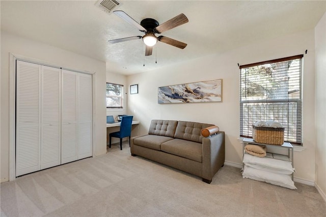 carpeted living room featuring ceiling fan