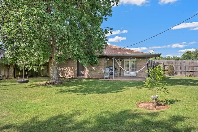 3108 Bluestem Dr, College Station, TX 77845 - rear view of property with french doors, brick siding, and a patio