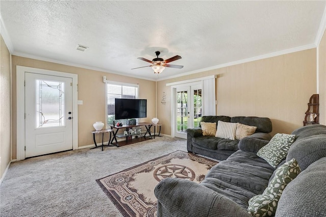 3108 Bluestem Dr, College Station, TX 77845 - carpeted living area with french doors, ornamental molding, ceiling fan, baseboards, and a textured ceiling