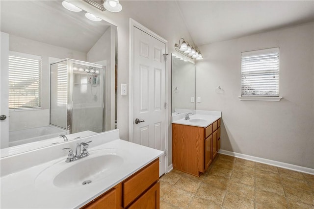 bathroom featuring vanity, vaulted ceiling, and shower with separate bathtub