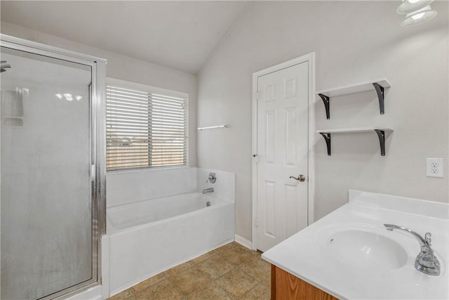 bathroom featuring tile patterned floors, vanity, separate shower and tub, and vaulted ceiling