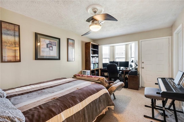 bedroom featuring light carpet, ceiling fan, and a textured ceiling