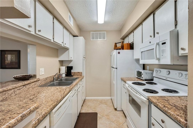 kitchen with white appliances, visible vents, a textured ceiling, white cabinetry, and a sink