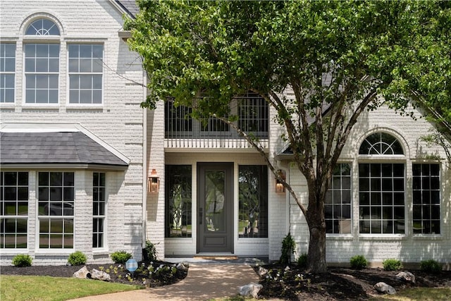 1107 Royal Adelade Dr, College Station, TX 77845 - doorway to property with brick siding and a balcony