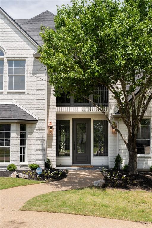 1107 Royal Adelade Dr, College Station, TX 77845 - view of exterior entry with a balcony and brick siding