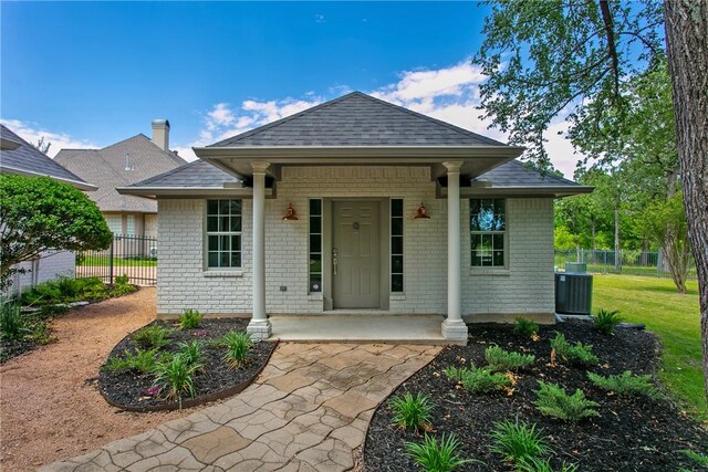 1107 Royal Adelade Dr, College Station, TX 77845 - view of side of home with a sunroom, roof with shingles, brick siding, and a lawn