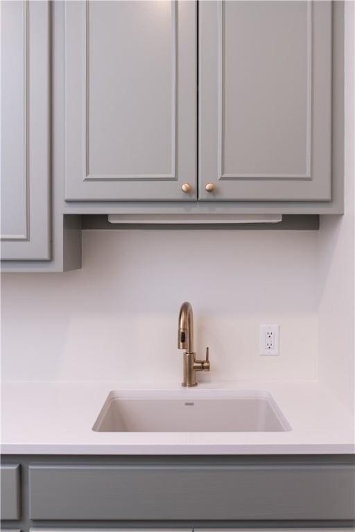 1107 Royal Adelade Dr, College Station, TX 77845 - interior details featuring gray cabinetry, light countertops, and a sink