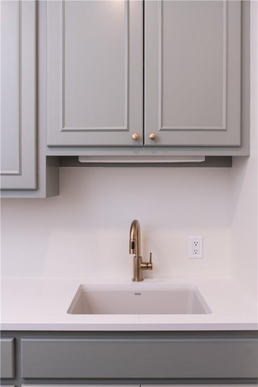 1107 Royal Adelade Dr, College Station, TX 77845 - interior details featuring gray cabinetry, light countertops, and a sink