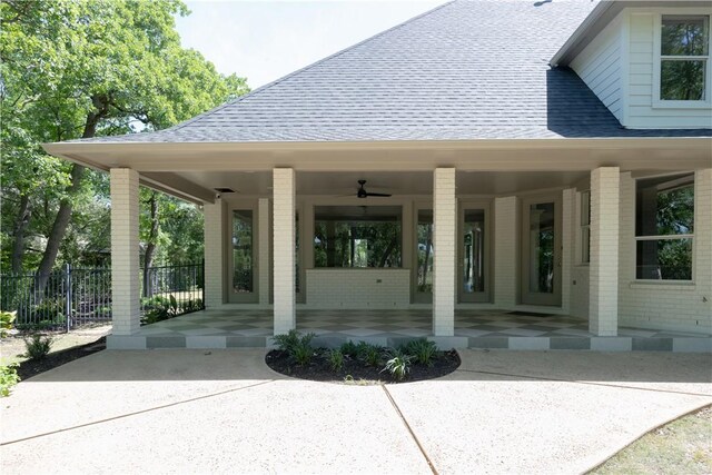 1107 Royal Adelade Dr, College Station, TX 77845 - view of exterior entry with roof with shingles, brick siding, fence, and a porch