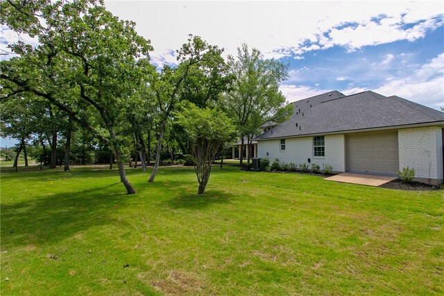 1107 Royal Adelade Dr, College Station, TX 77845 - view of green lawn featuring an attached garage