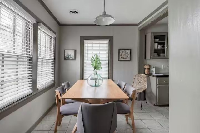 1017 Milner Dr, College Station, TX 77840 - dining room with plenty of natural light, light tile patterned flooring, and ornamental molding