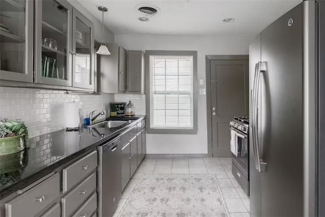 1017 Milner Dr, College Station, TX 77840 - kitchen with stainless steel appliances, gray cabinetry, a sink, decorative backsplash, and light tile patterned flooring