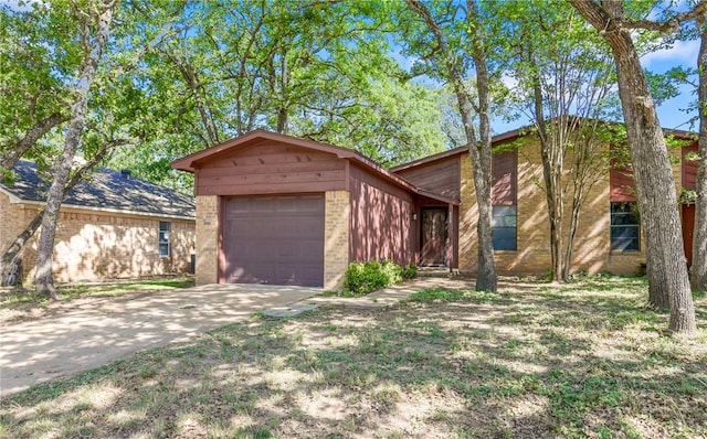 2212 Young Pl Unit A, Bryan, TX 77807 - view of front of house with brick siding, driveway, and a garage