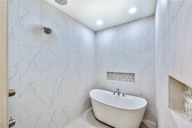 bathroom with tile walls and independent shower and bath