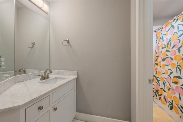 bathroom featuring baseboards and vanity