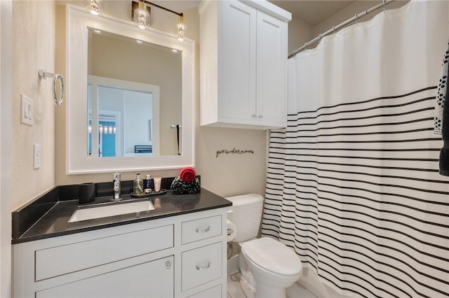 bathroom with vanity, a shower with shower curtain, and toilet