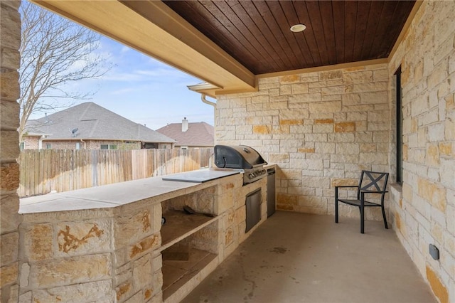 view of patio / terrace with area for grilling and fence