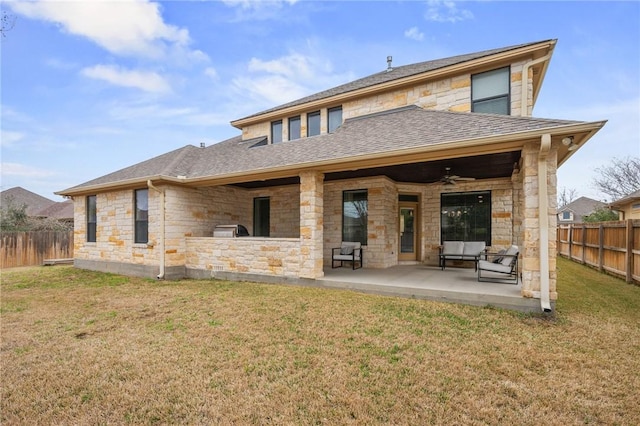 rear view of house with a yard, a patio, a fenced backyard, and a ceiling fan