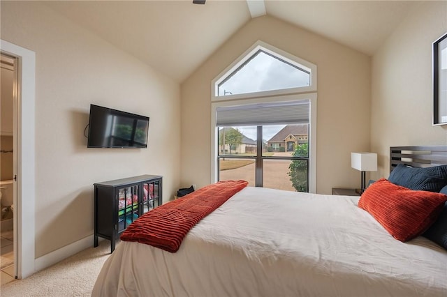 bedroom with vaulted ceiling, baseboards, and carpet floors