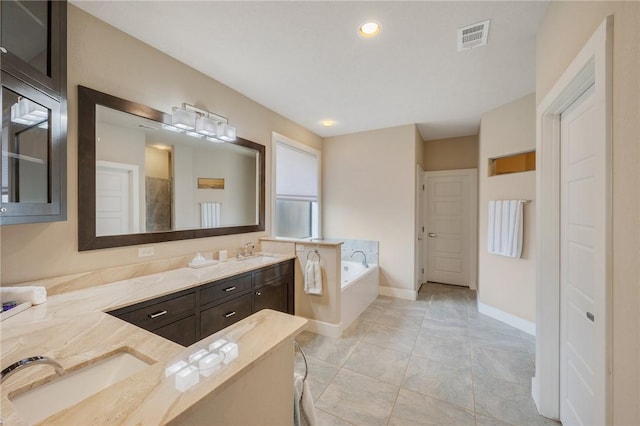 bathroom featuring vanity, baseboards, visible vents, recessed lighting, and a garden tub