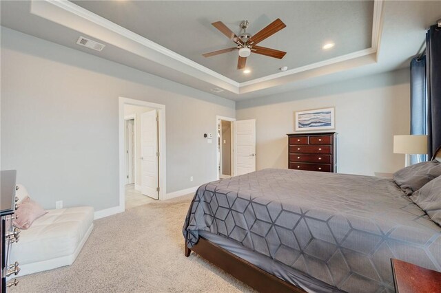 bedroom with visible vents, a raised ceiling, light colored carpet, and baseboards