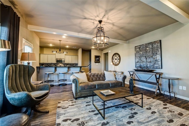 living room with dark hardwood / wood-style flooring, a notable chandelier, and beamed ceiling