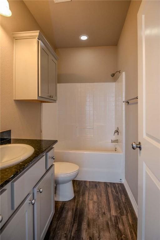 full bathroom featuring wood-type flooring, shower / washtub combination, vanity, and toilet