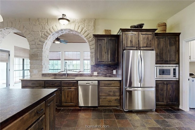 7576 River Ridge Drive, College Station, TX 77845 - kitchen with stainless steel appliances, dark stone finish flooring, tasteful backsplash, and a ceiling fan