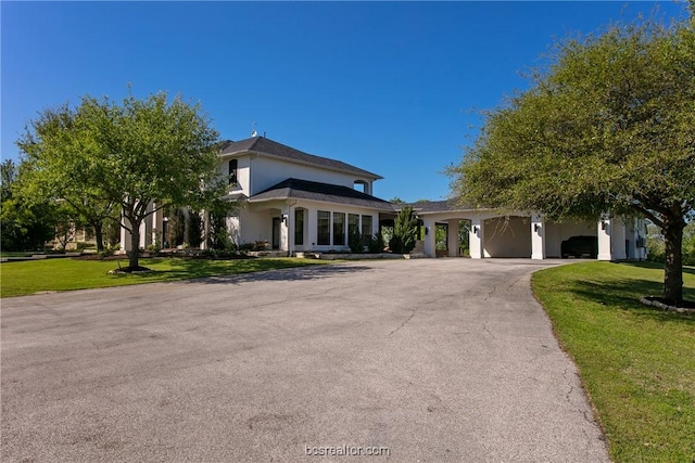 7576 River Ridge Drive, College Station, TX 77845 - view of front of home featuring a front yard, curved driveway, stucco siding, and a garage