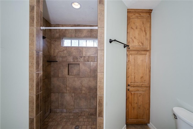 bathroom featuring a shower stall and toilet