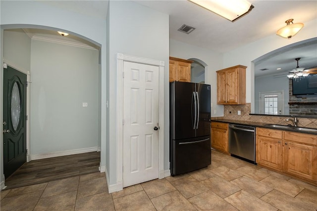 kitchen featuring a sink, visible vents, freestanding refrigerator, dishwasher, and dark countertops