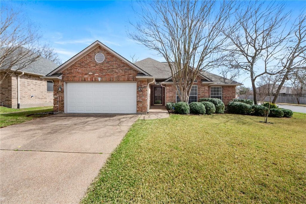 single story home with a shingled roof, concrete driveway, a front lawn, a garage, and brick siding