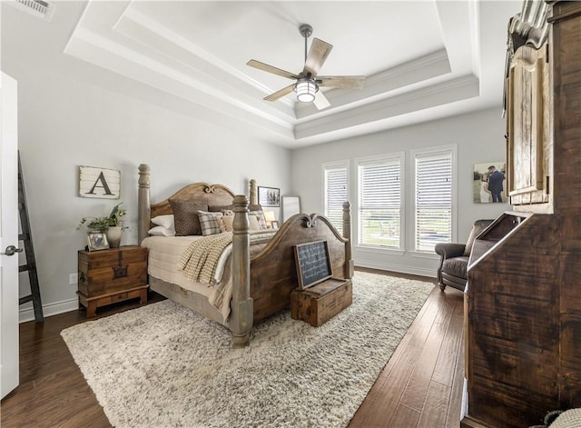 5149 Mandarin Way, College Station, TX 77845 - bedroom with a raised ceiling, dark wood-type flooring, and a ceiling fan