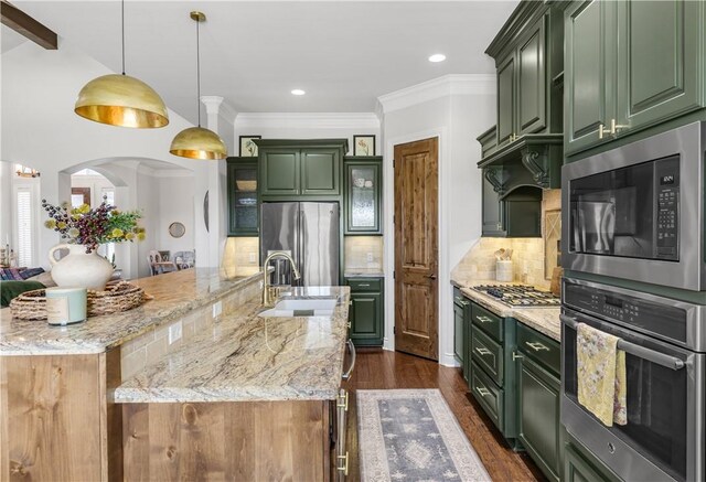 5149 Mandarin Way, College Station, TX 77845 - kitchen with green cabinets, appliances with stainless steel finishes, a large island, light stone counters, and crown molding