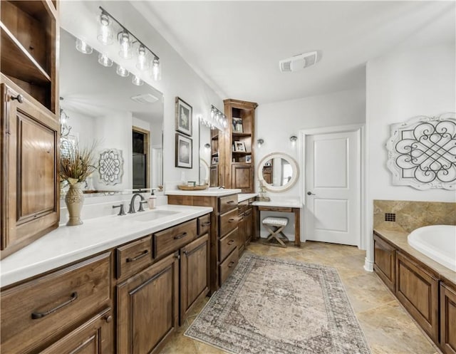 5149 Mandarin Way, College Station, TX 77845 - bathroom featuring vanity, a garden tub, and stone finish floors