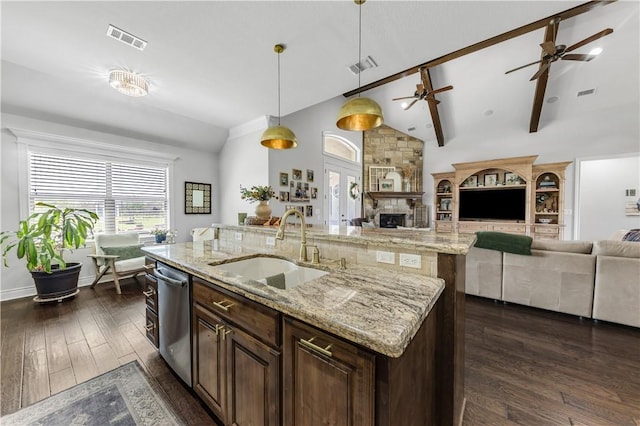 5149 Mandarin Way, College Station, TX 77845 - kitchen with dishwasher, open floor plan, an island with sink, decorative light fixtures, and dark wood finished floors