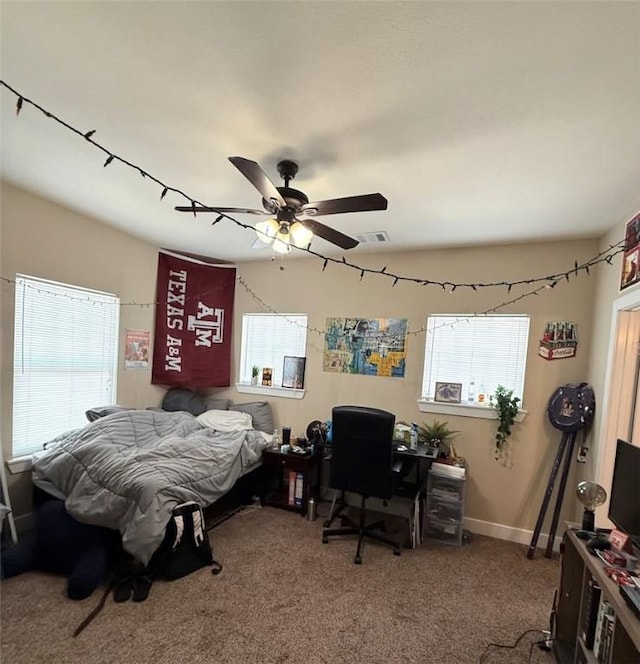 4004 Oaklawn St, Bryan, TX 77801 - carpeted bedroom with a desk and ceiling fan