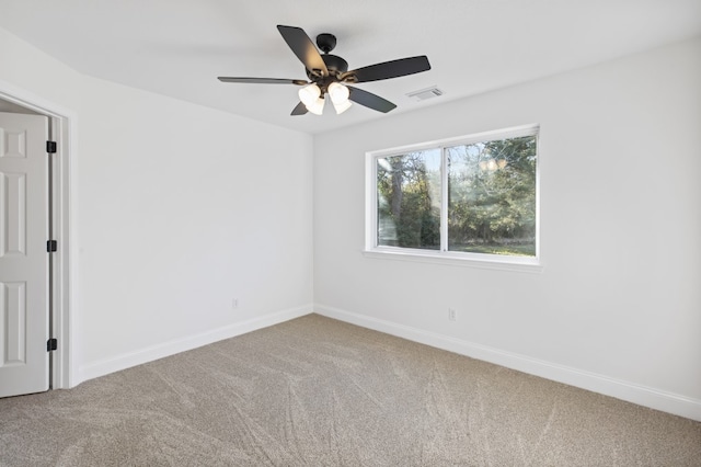 unfurnished room featuring ceiling fan and carpet floors