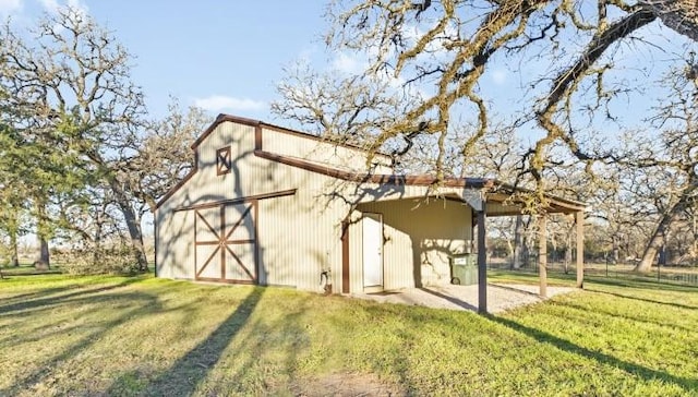 exterior space with an outdoor structure and a lawn