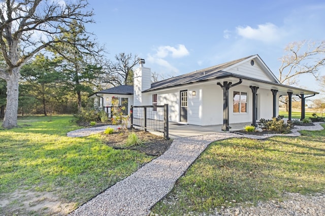 single story home featuring covered porch and a front yard